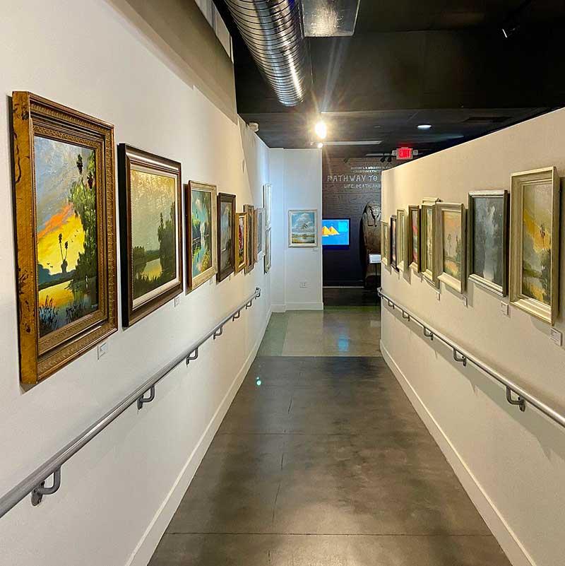 Gallery display, "Florida Highwaymen Painting Paradise", St. Petersburg Museum of History.